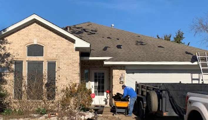 Roof being repaired on home